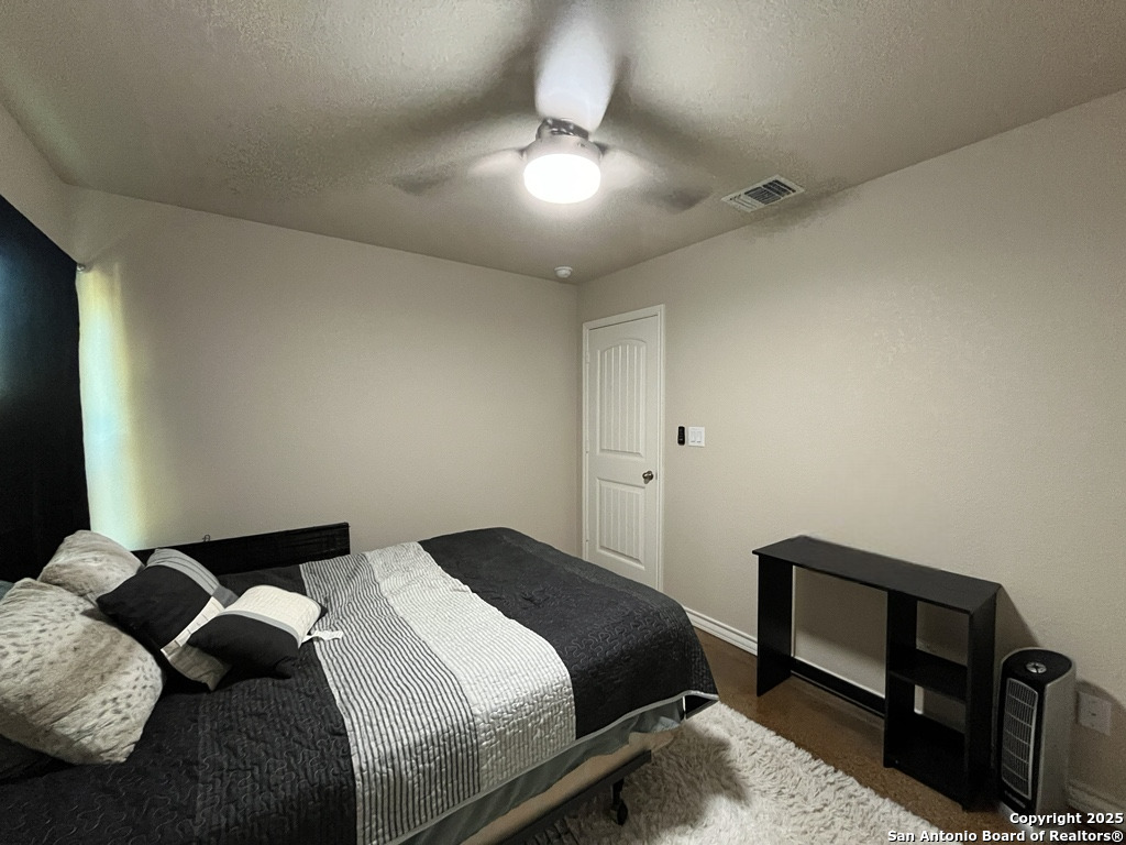 2708 Golf Drive Spring Branch, TX 78070 - Photo 16 of 31 a bedroom with a bed and a lamp on dresser