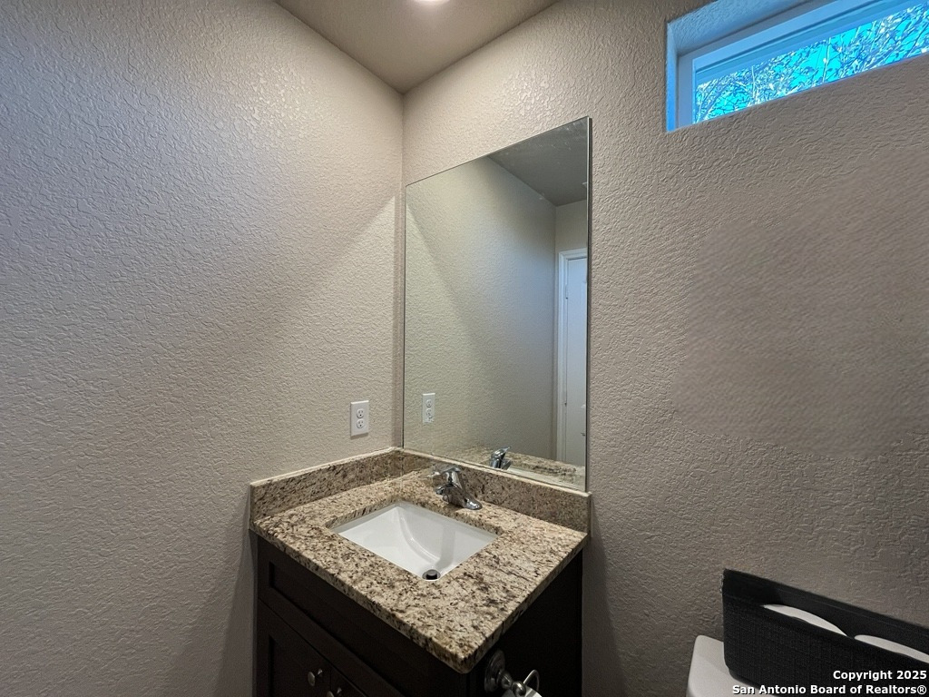 2708 Golf Drive Spring Branch, TX 78070 - Photo 17 of 31 a bathroom with a granite countertop sink and a mirror