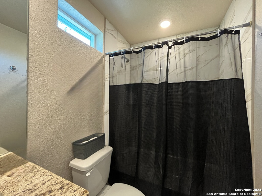 2708 Golf Drive Spring Branch, TX 78070 - Photo 18 of 31 a bathroom with a shower curtain and sink