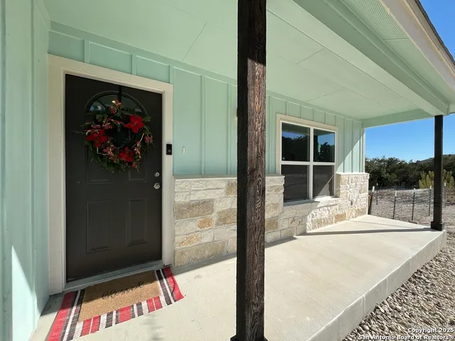 a picture of a room with a bench and a wooden floor
