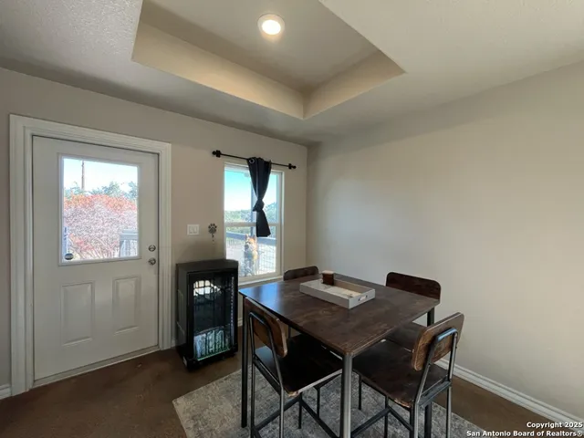 a living room with lots of furniture and kitchen view