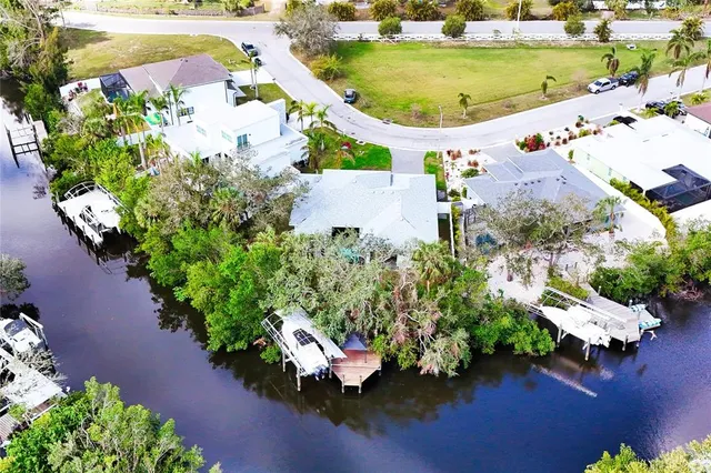 an aerial view of a house with a garden and swimming pool