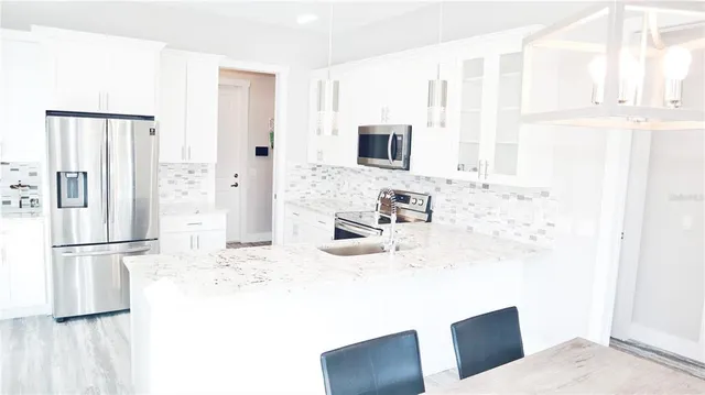 a view of a dining room with furniture and a window