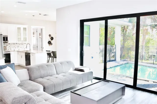 a kitchen with a table chairs and a large window