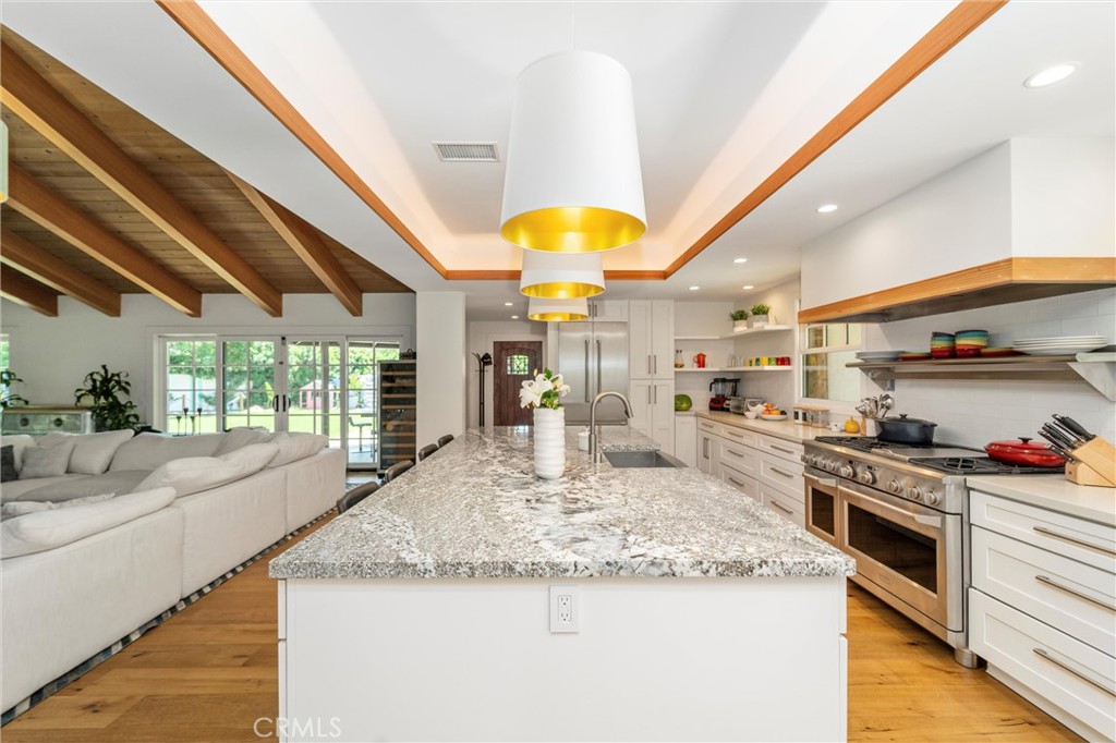 7337 La Soldadera Rancho Santa Fe, CA 92067 - Photo 11 of 60 a kitchen with stainless steel appliances granite countertop sink stove and cabinets
