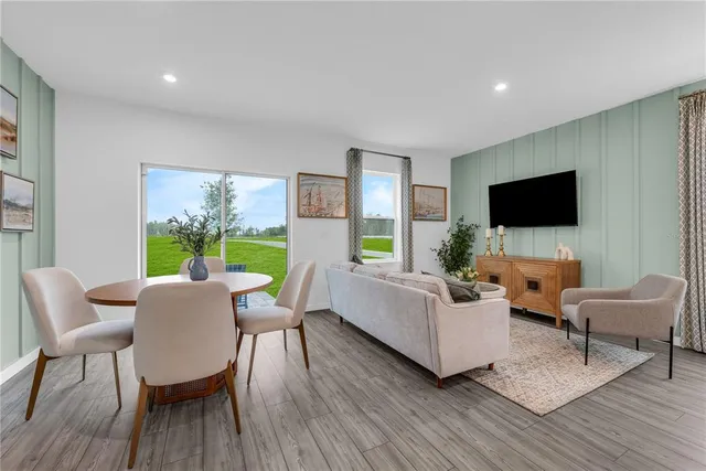a living room with furniture and a view of kitchen