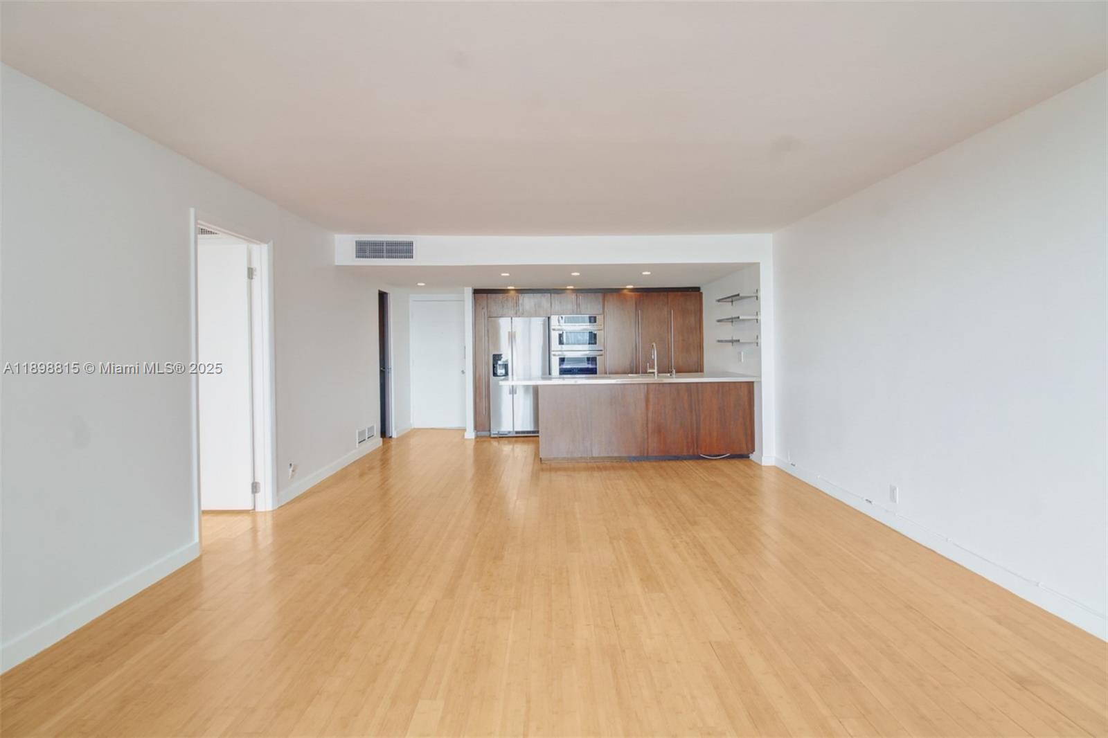 5 Island Avenue, Unit 4E Miami Beach, FL 33139 - Photo 11 of 23 a big room with wooden floor and a kitchen