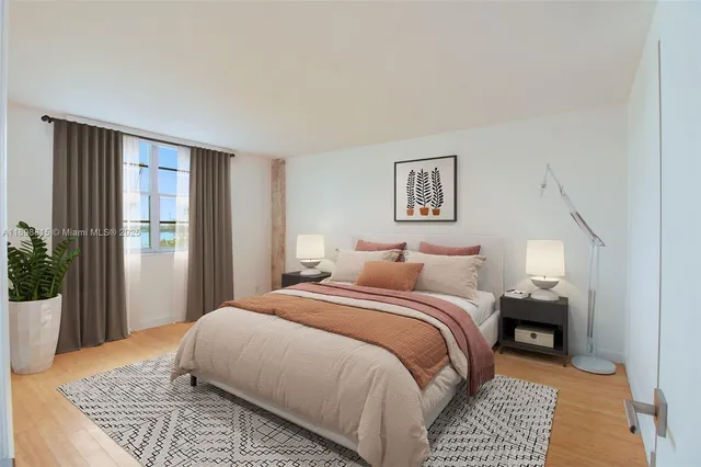 a bedroom with a large bed and a window