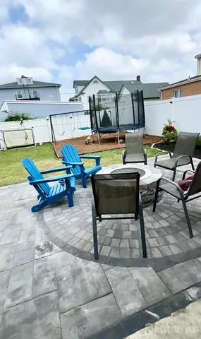 a living room with furniture a flat screen tv and lawn chairs