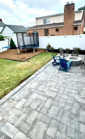 a backyard of a house with barbeque oven table and chairs