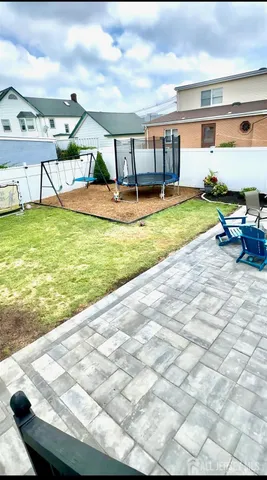 a view of a house with a backyard porch and sitting area
