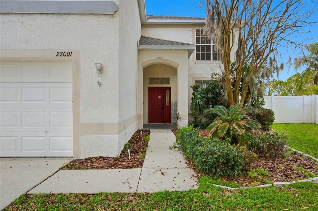 a front view of a house with garden