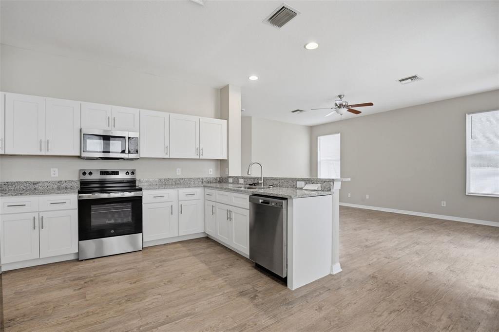 27001 Arrowbrook Way Wesley Chapel, FL 33544 - Photo 15 of 44 a kitchen with stainless steel appliances granite countertop a stove and a sink