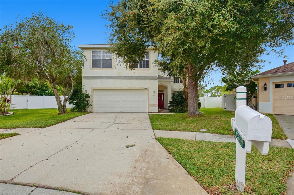 27001 Arrowbrook Way Wesley Chapel, FL 33544 - Photo 2 of 44 a front view of a house with a yard and garage