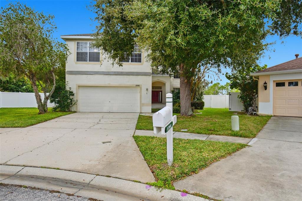 27001 Arrowbrook Way Wesley Chapel, FL 33544 - Photo 3 of 44 a front view of a house with yard and tree