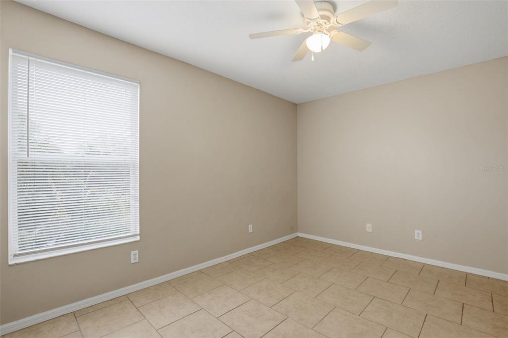 27001 Arrowbrook Way Wesley Chapel, FL 33544 - Photo 32 of 44 an empty room with a chandelier fan and windows