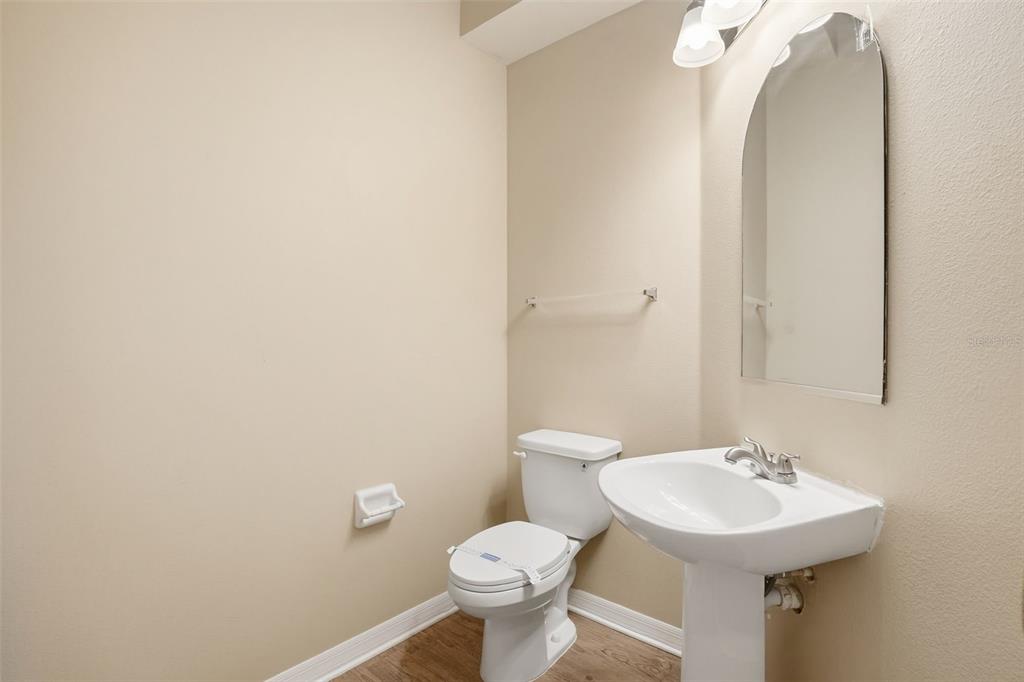 27001 Arrowbrook Way Wesley Chapel, FL 33544 - Photo 36 of 44 a bathroom with a sink a toilet and a mirror