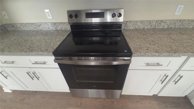 a stove top oven sitting inside of a kitchen