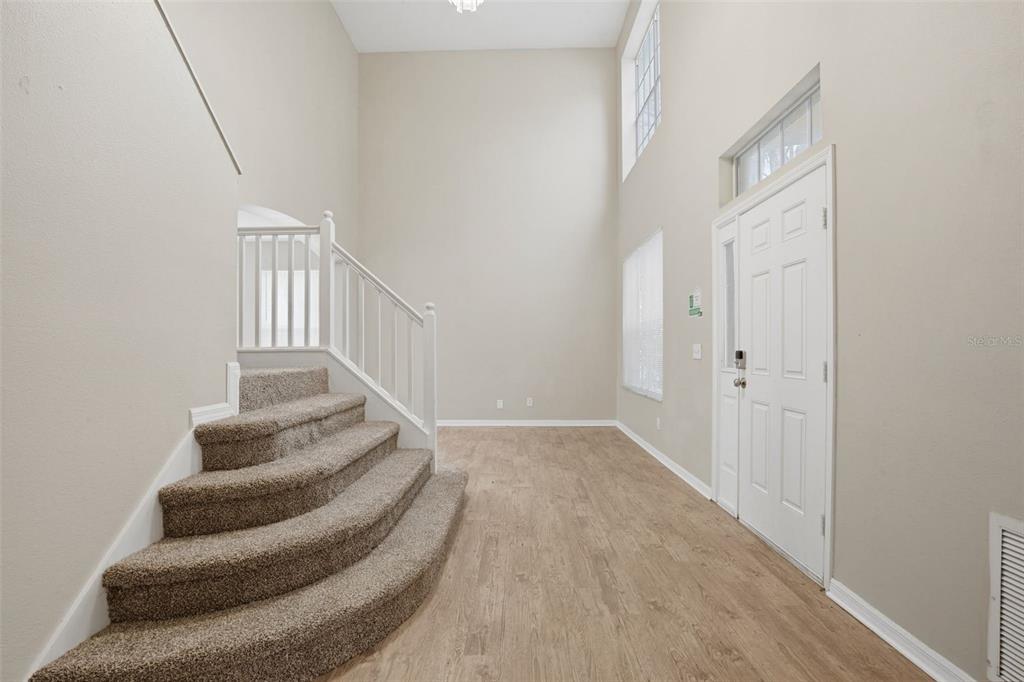 27001 Arrowbrook Way Wesley Chapel, FL 33544 - Photo 9 of 44 a view of entryway and hall with wooden floor