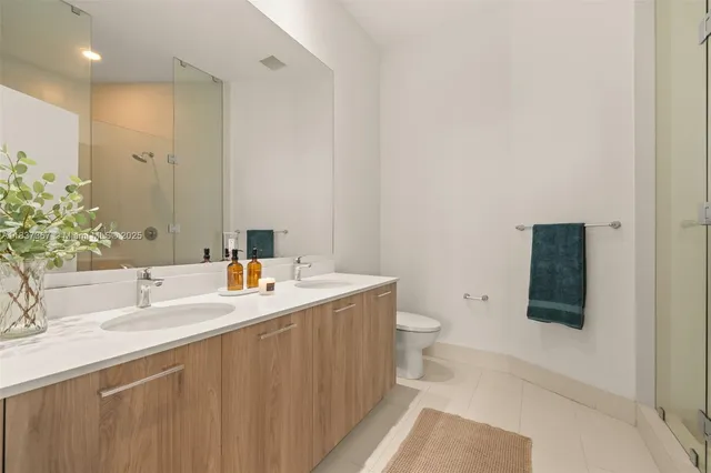 a bedroom with a bed and lamp on desk