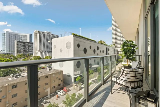 a living room filled with furniture and a potted plant