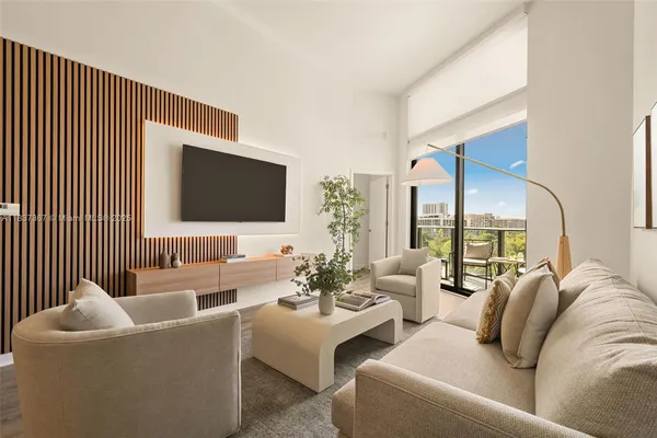 a bedroom with a bed and a flat tv screen on dresser