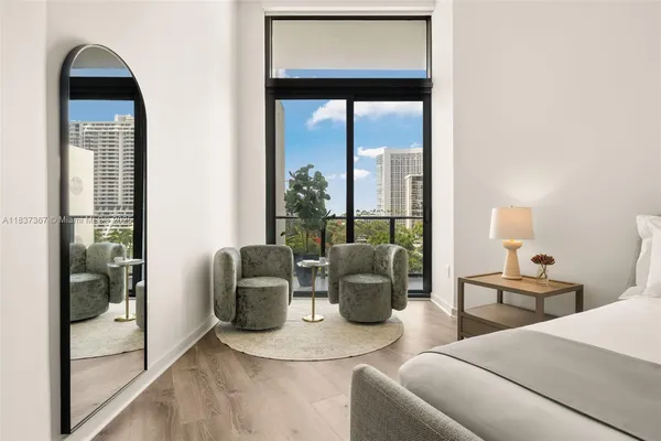 a kitchen with sink refrigerator dining table and chairs