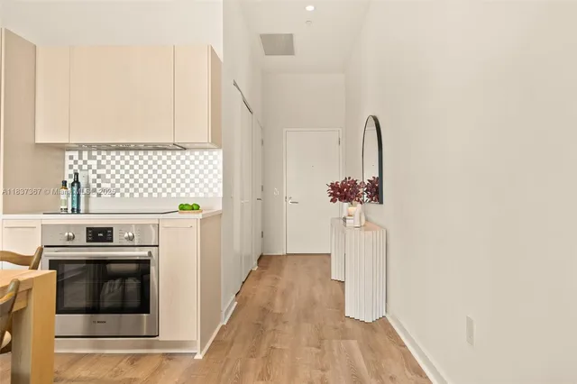 a dining room with furniture a rug and wooden floor