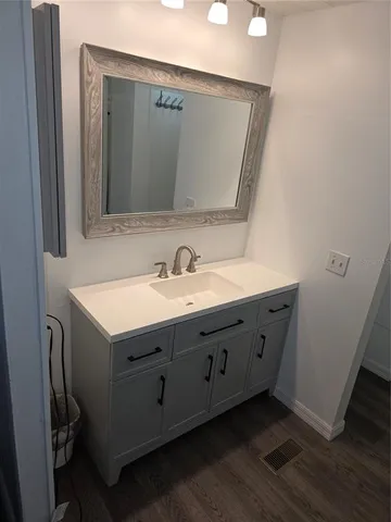 a bathroom with a double vanity sink and mirror