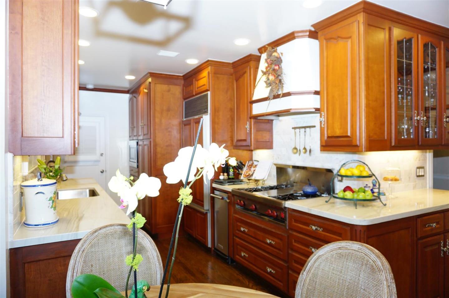 440 Edgewood Road San Mateo, CA 94402 - Photo 15 of 39 a kitchen with a stove a table and chairs in it