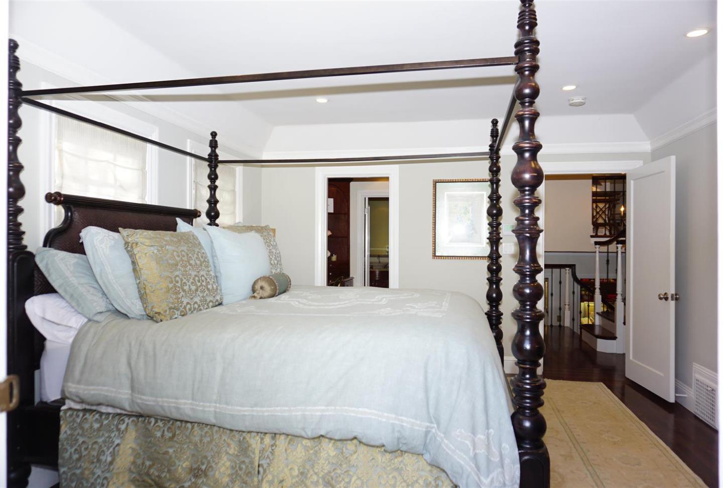 440 Edgewood Road San Mateo, CA 94402 - Photo 20 of 39 a bedroom with a bed window and a chandelier