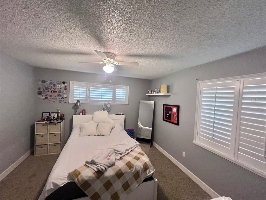 357 Tymber Run Ormond Beach, FL 32174 - Photo 25 of 32 a bedroom with a large bed and a window