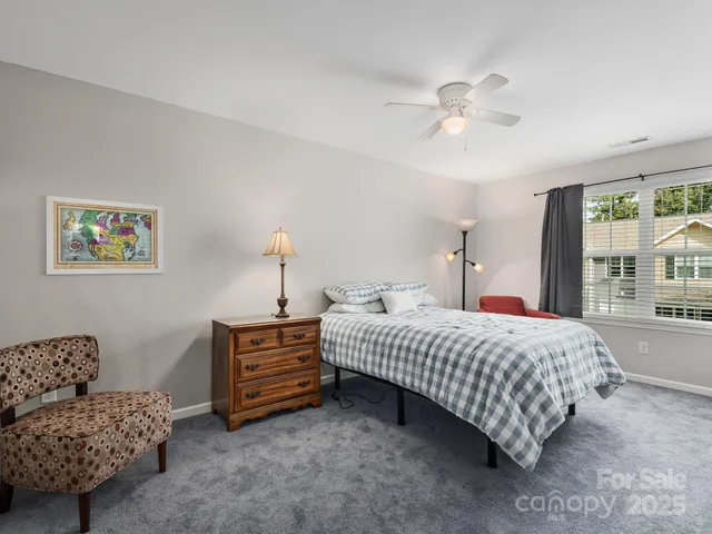 a bedroom with a bed and ceiling fan