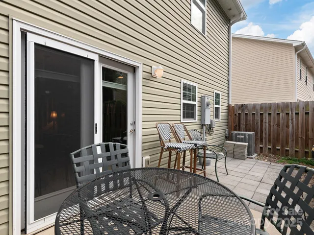 a patio with table and chairs