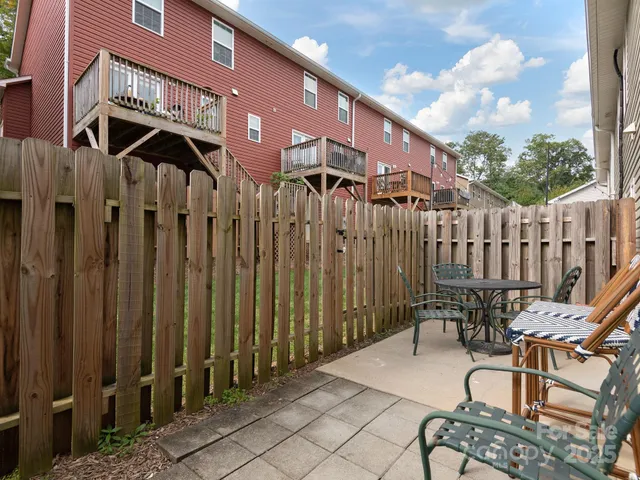 a view of a chairs and table in backyard