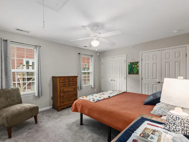 a bedroom with a bed a couch and a window