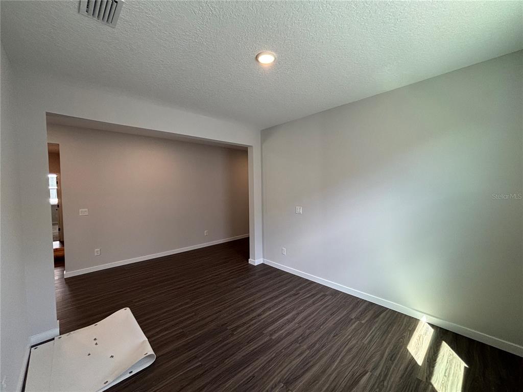 63 Pegasus Road Flagler Beach, FL 32136 - Photo 12 of 35 an empty room with wooden floor and windows