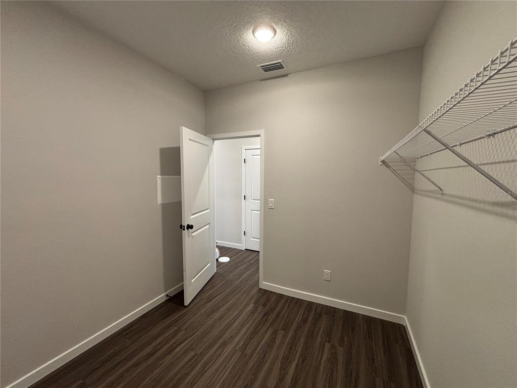 63 Pegasus Road Flagler Beach, FL 32136 - Photo 15 of 35 a view of a room with wooden floor and a ceiling fan