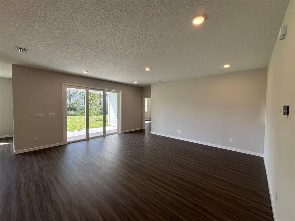 63 Pegasus Road Flagler Beach, FL 32136 - Photo 19 of 35 a view of an empty room with wooden floor and a window
