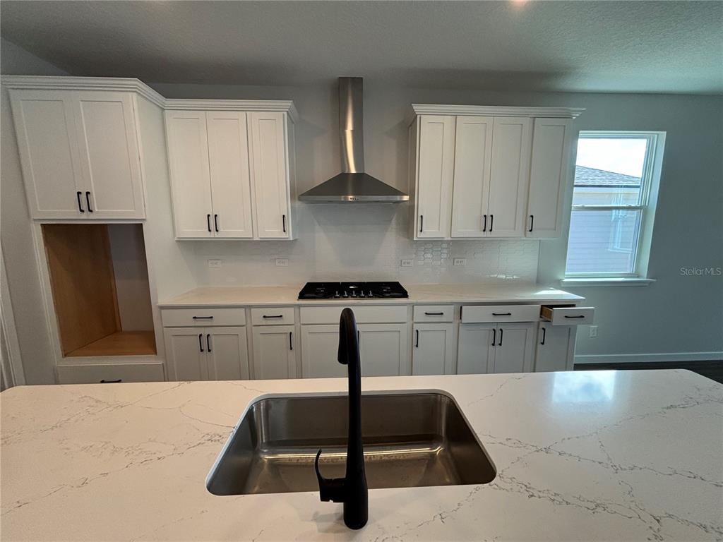 63 Pegasus Road Flagler Beach, FL 32136 - Photo 22 of 35 a kitchen with kitchen island a counter top space cabinets and stainless steel appliances