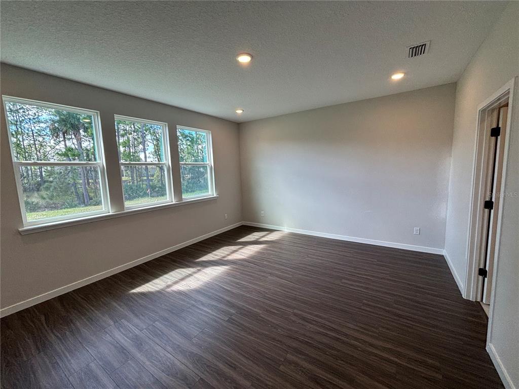 63 Pegasus Road Flagler Beach, FL 32136 - Photo 26 of 35 a view of an empty room with wooden floor and a window