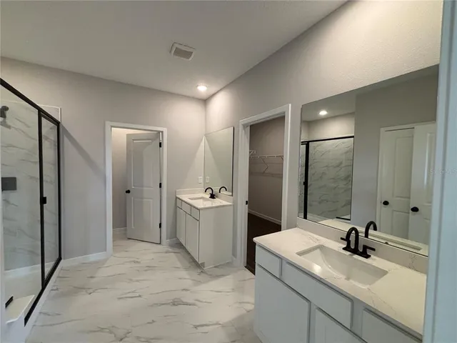 a view of a hallway with wooden floor and glass door