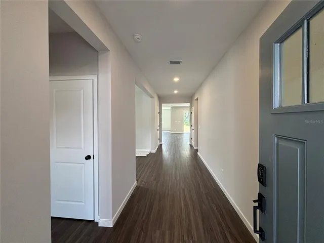 a bathroom with a granite countertop sink a toilet and shower