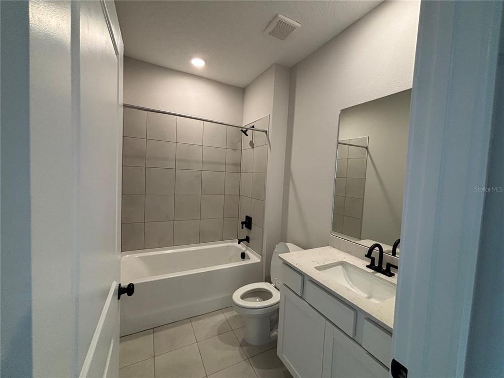 63 Pegasus Road Flagler Beach, FL 32136 - Photo 8 of 35 a bathroom with a granite countertop sink a toilet and shower