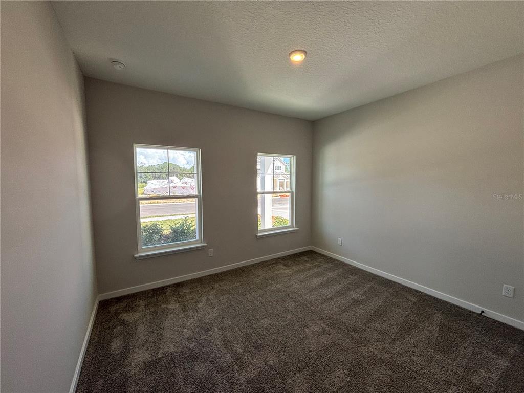 63 Pegasus Road Flagler Beach, FL 32136 - Photo 9 of 35 an empty room with windows