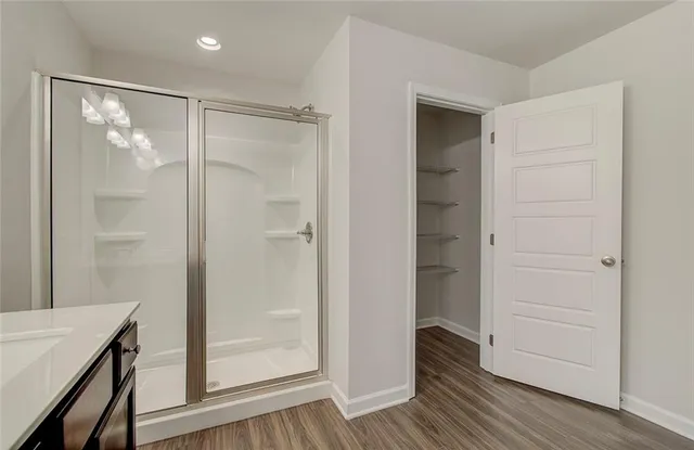 a bathroom with a shower and a glass door