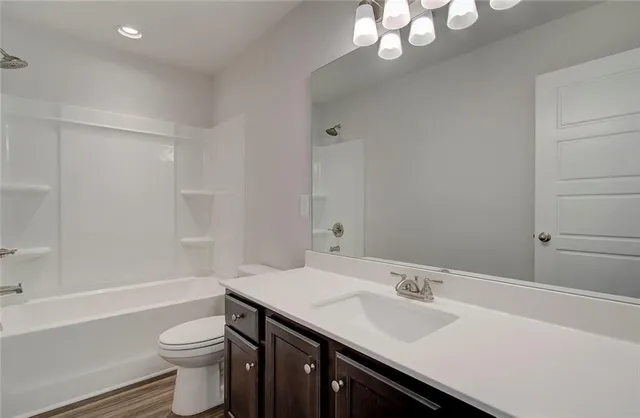 a view of a room with wooden floor and white walls
