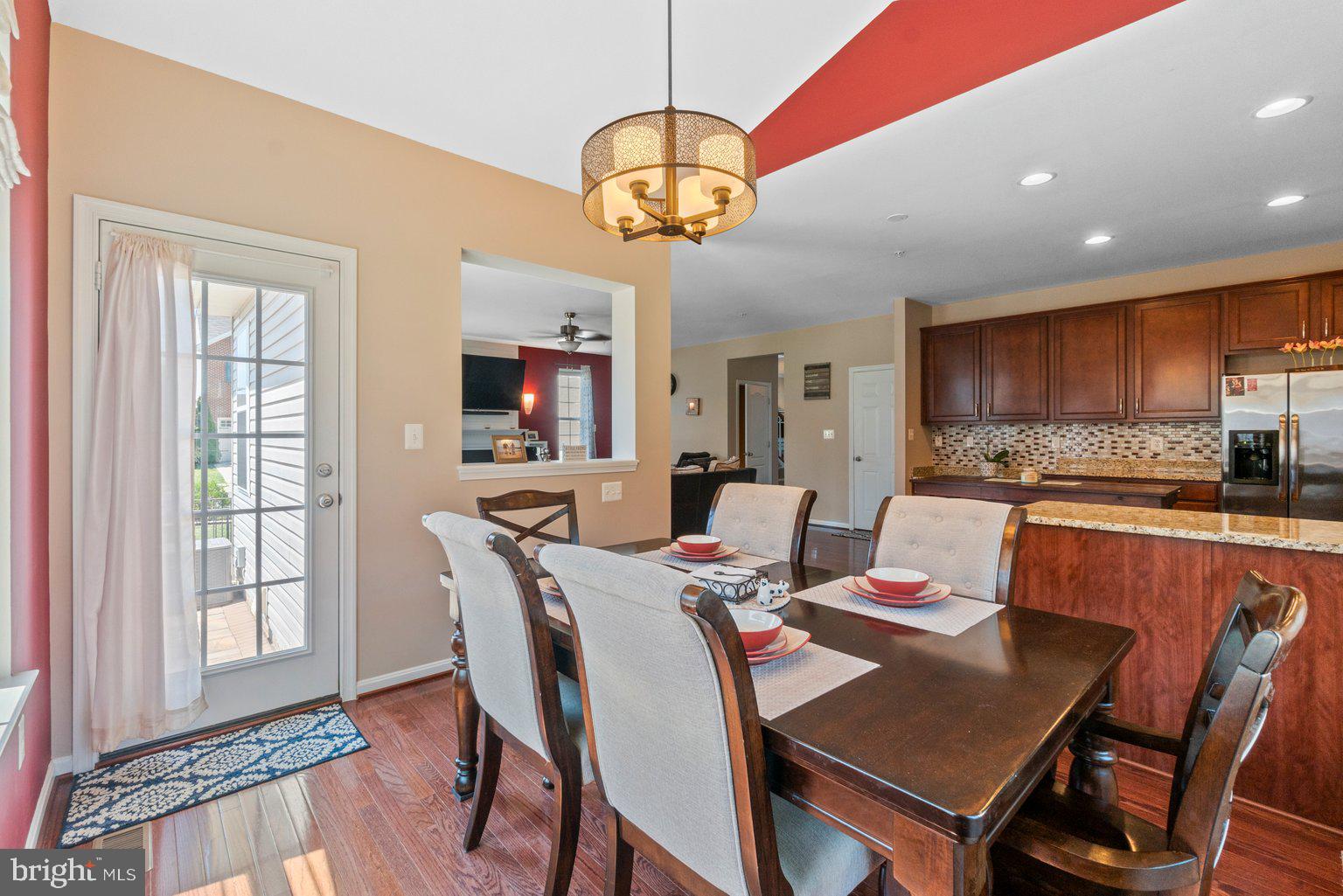900 McCune Road Middle River, MD 21220 - Photo 19 of 55 a view of a dining room with furniture a chandelier and wooden floor