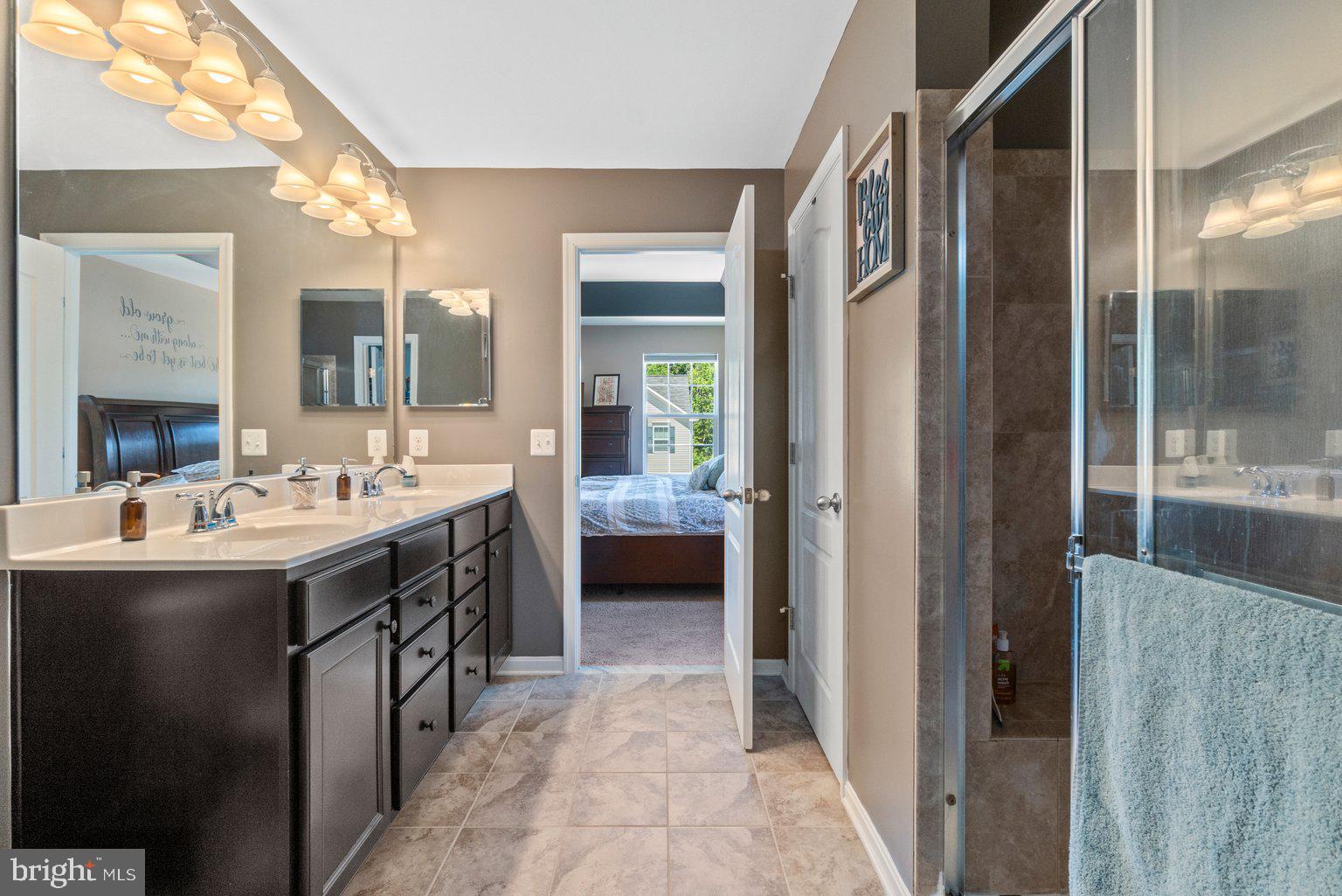 900 McCune Road Middle River, MD 21220 - Photo 28 of 55 a en suite bathroom with a double vanity sink a mirror and a shower