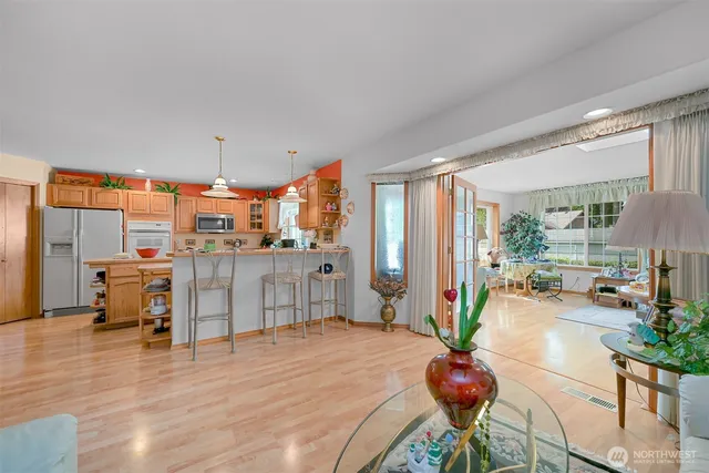 a living room with furniture a wooden floor and a large window